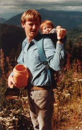 Tom Paulsen handing his young daughter Kristine a huckleberry