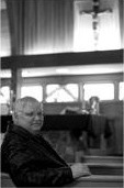Mike Noble seated in a church pew